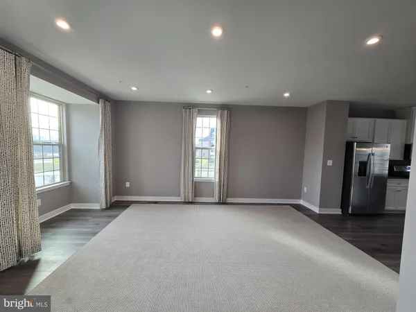 a view of a livingroom with furniture and staircase