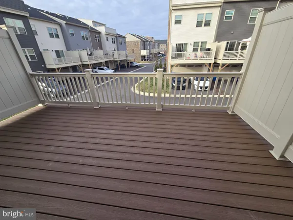 a view of front door deck and wooden floor