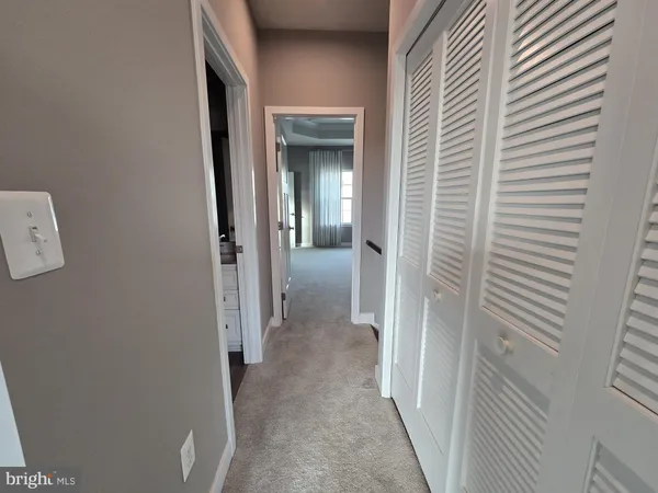 a view of an empty room and closet area