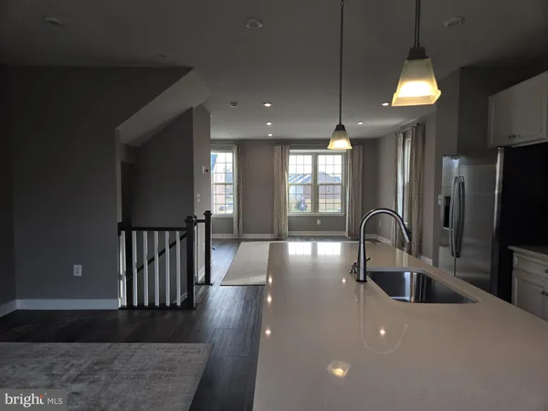 a kitchen with counter top space a sink and refrigerator