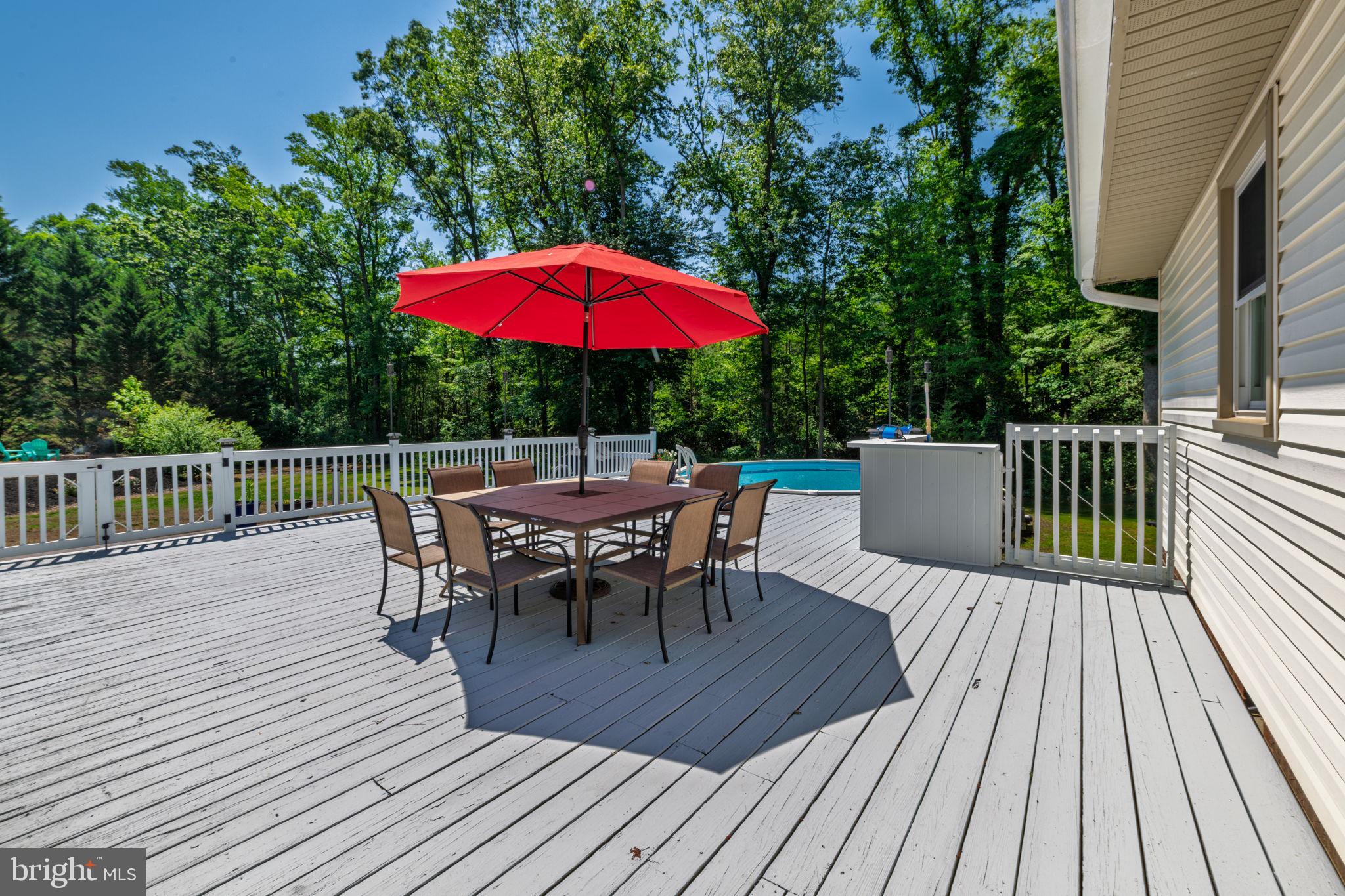 4563 Nutters Cross Road Salisbury, MD 21804 - Photo 11 of 52 a view of a roof deck with table and chairs