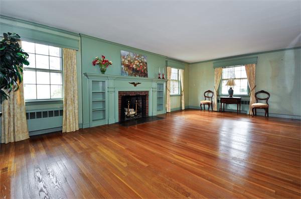 19 Bernard Road Wellesley, MA 02481 - Photo 4 of 24 a view of empty room with fireplace wooden floor and windows