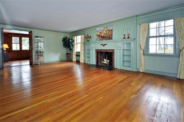 19 Bernard Road Wellesley, MA 02481 - Photo 5 of 24 an empty room with wooden floor fireplace and windows