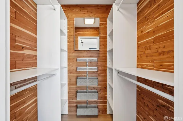a view of a room with wooden floor and windows