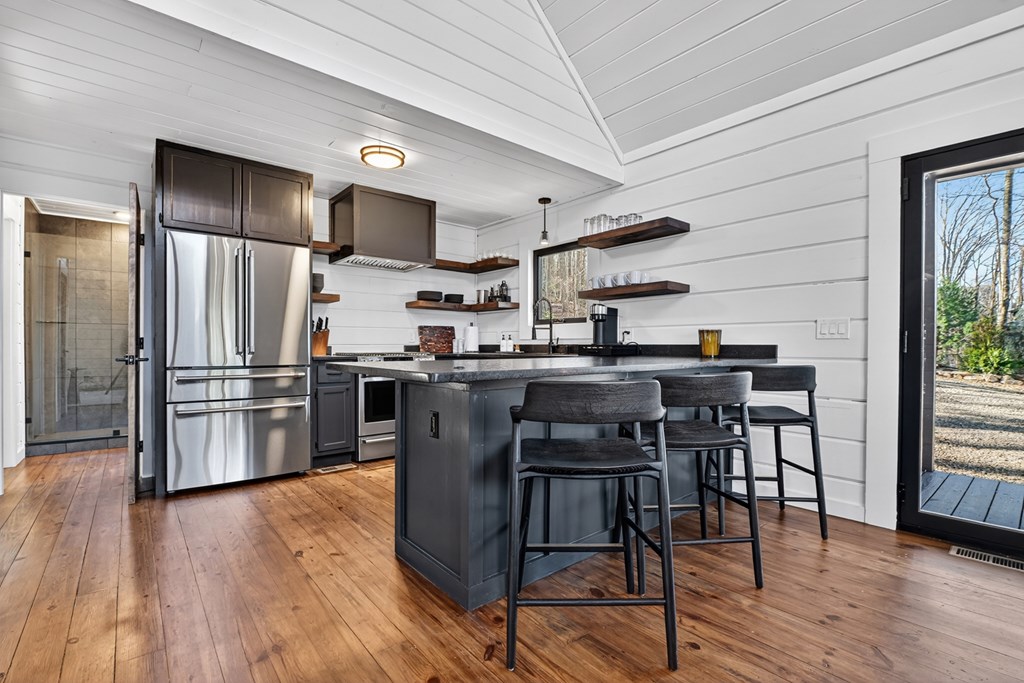 427 Green Ridge Road Blue Ridge, GA 30513 - Photo 13 of 53 a kitchen with stainless steel appliances a refrigerator a stove a sink dishwasher a dining table and chairs with wooden floor