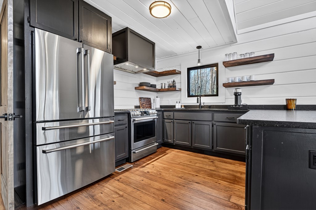 427 Green Ridge Road Blue Ridge, GA 30513 - Photo 4 of 53 a kitchen with stainless steel appliances a refrigerator a sink and wooden floors