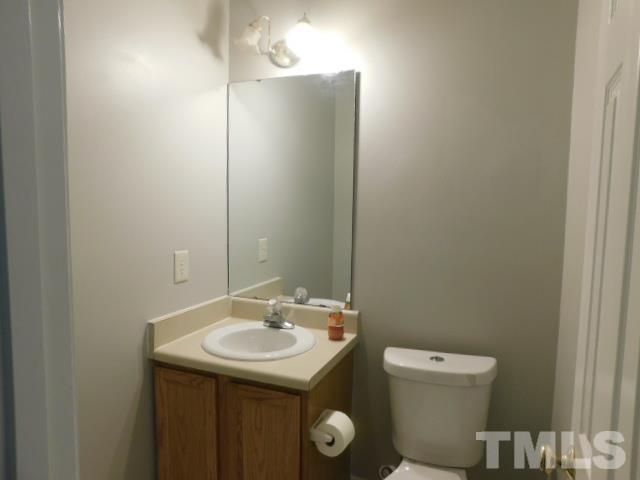 4121 Beaufain Street Raleigh, NC 27604 - Photo 13 of 18 a bathroom with a sink a toilet and mirror