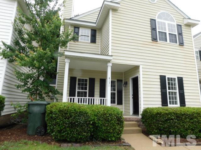 4121 Beaufain Street Raleigh, NC 27604 - Photo 3 of 18 a view of a white house with large windows and plants
