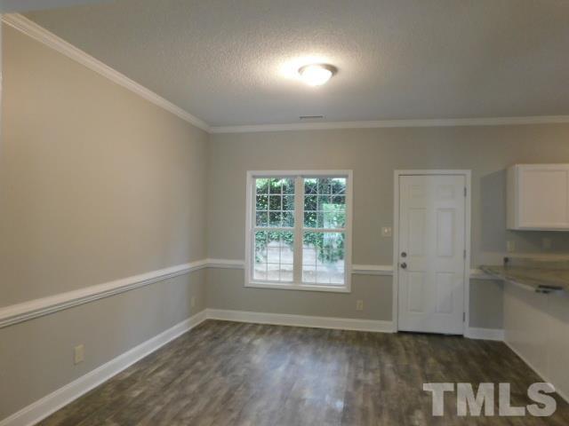 4121 Beaufain Street Raleigh, NC 27604 - Photo 8 of 18 an empty room with wooden floor and windows