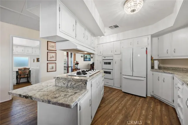 a kitchen with white cabinets and appliances