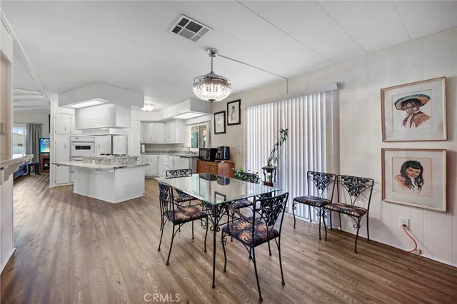 a view of a dining room with furniture wooden floor and chandelier