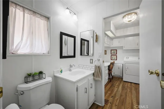 a bathroom with a sink toilet and mirror