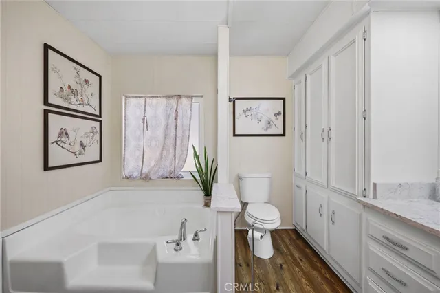 a bathroom with a bathtub and toilet