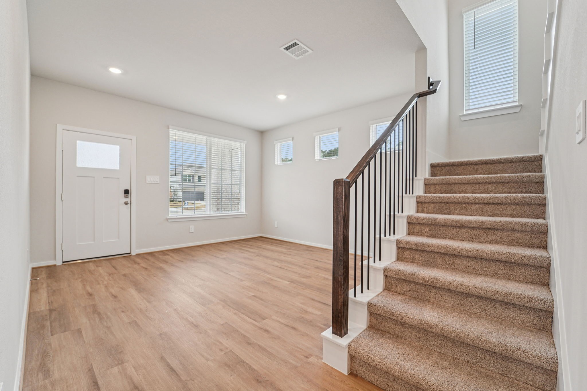 16217 Parish Pointe Court Conroe, TX 77302 - Photo 11 of 42 a view of entryway with wooden floor and stairs