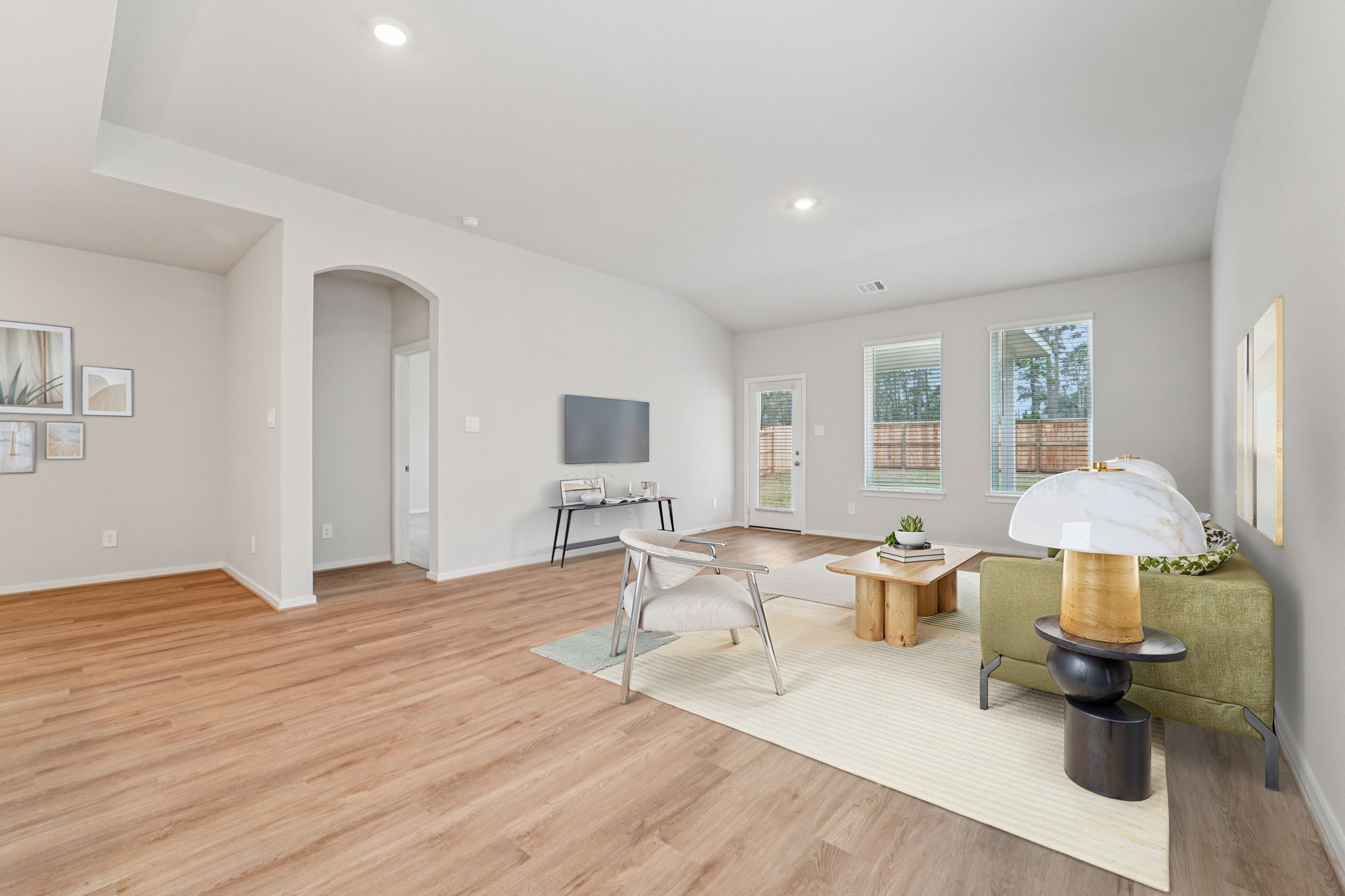 16217 Parish Pointe Court Conroe, TX 77302 - Photo 3 of 42 a living room with furniture a table and a painting on the wall