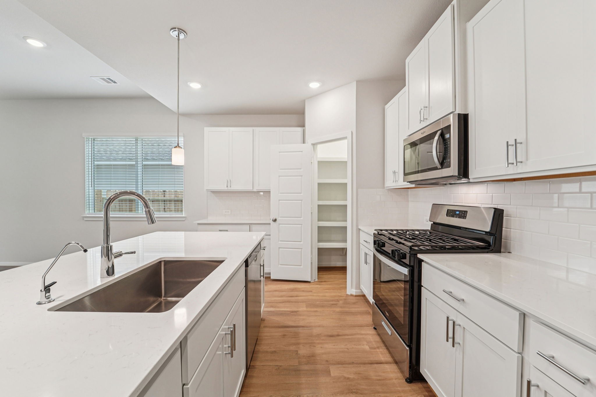 16217 Parish Pointe Court Conroe, TX 77302 - Photo 10 of 42 a kitchen with a sink stove top oven and refrigerator