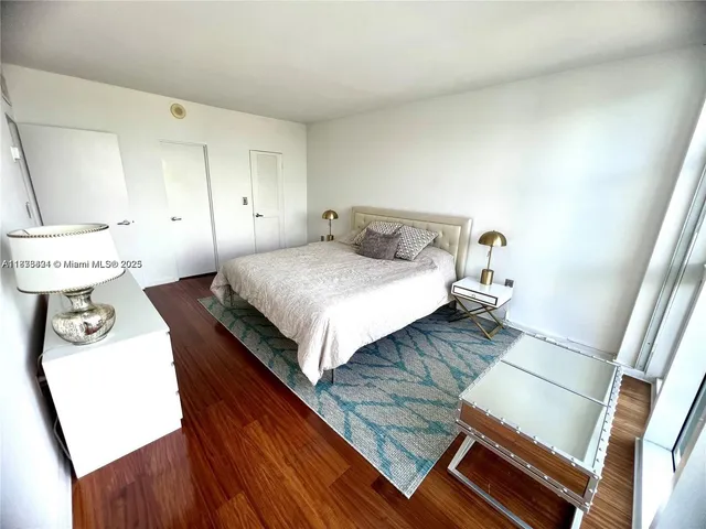 a bedroom with a bed and a table