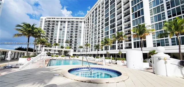 a view of building with swimming pool and seating