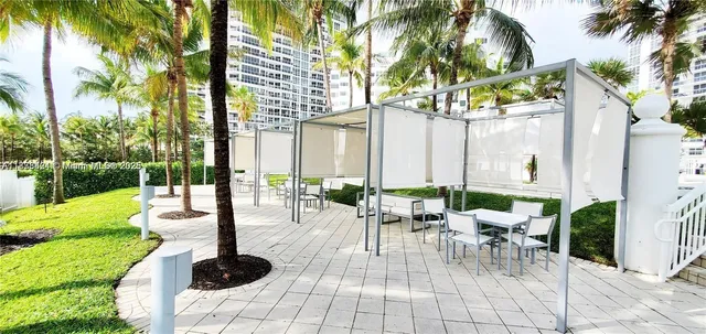 a view of a patio with a table and chairs