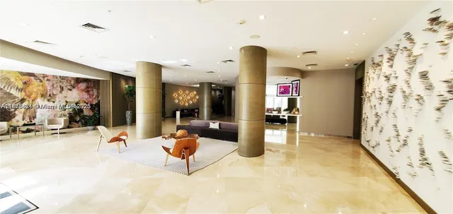 a living room with furniture floor to ceiling window and wooden floor