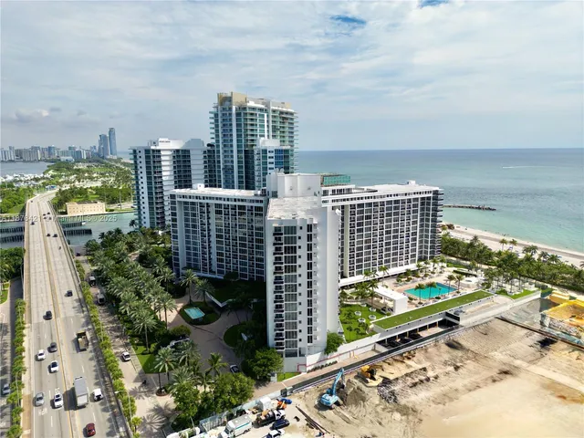 a view of a backyard with sitting area and potted plants