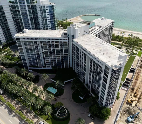 an aerial view of a house with a garden and lake view