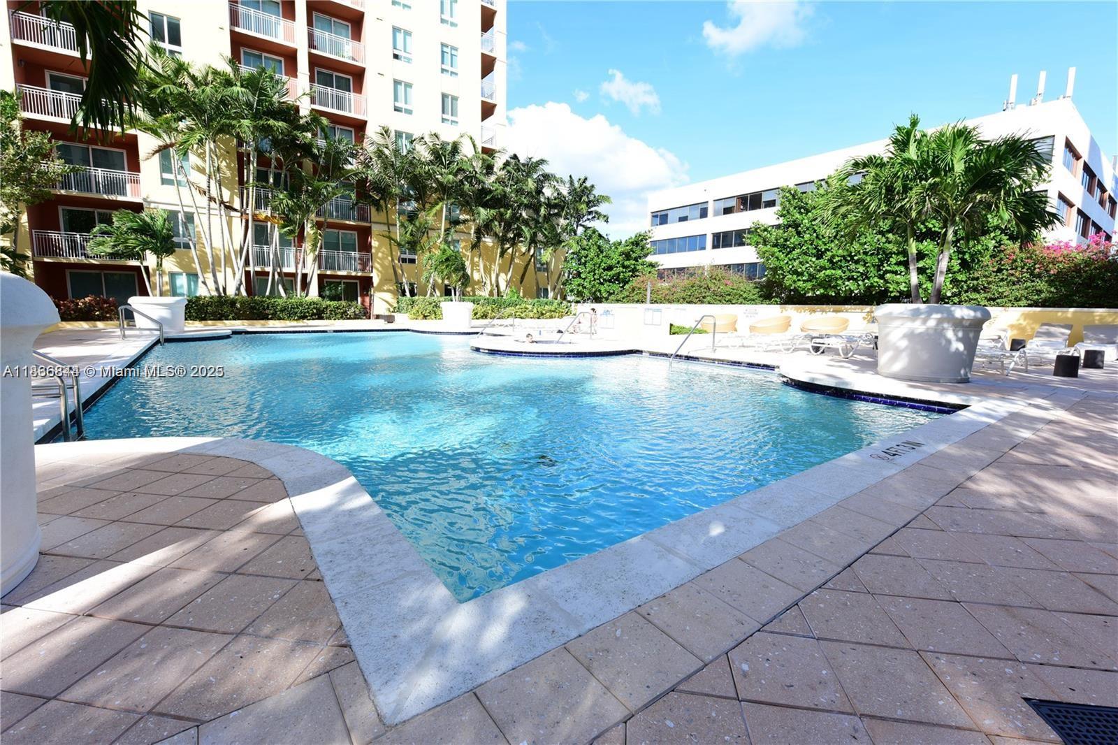 7355 Southwest 89th Street, Unit 622N Miami, FL 33156 - Photo 14 of 16 a view of a swimming pool with a patio