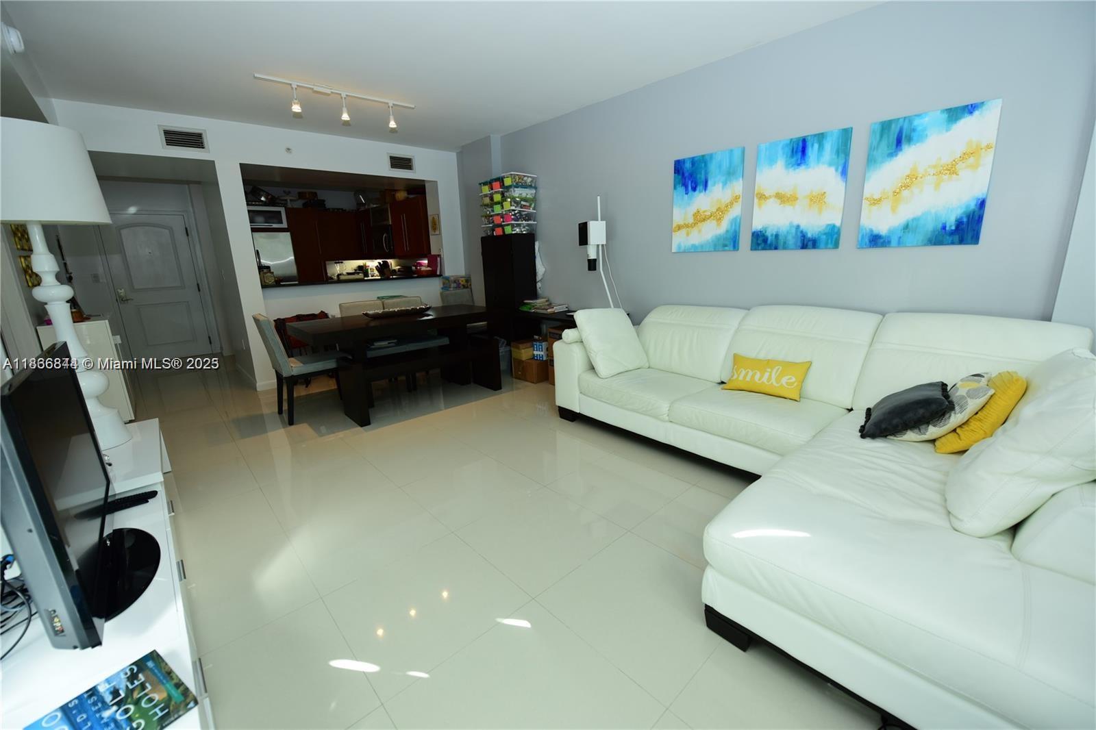 7355 Southwest 89th Street, Unit 622N Miami, FL 33156 - Photo 2 of 16 a living room with furniture and a flat screen tv
