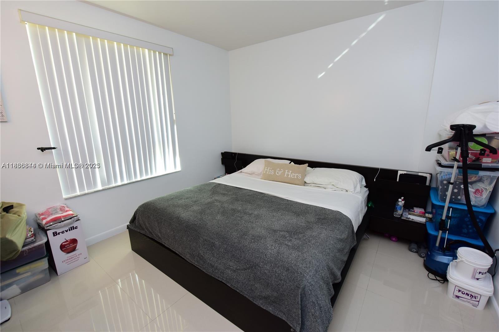 7355 Southwest 89th Street, Unit 622N Miami, FL 33156 - Photo 8 of 16 a bedroom with a bed and a window