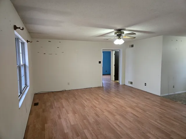 wooden floor in an empty room with a window