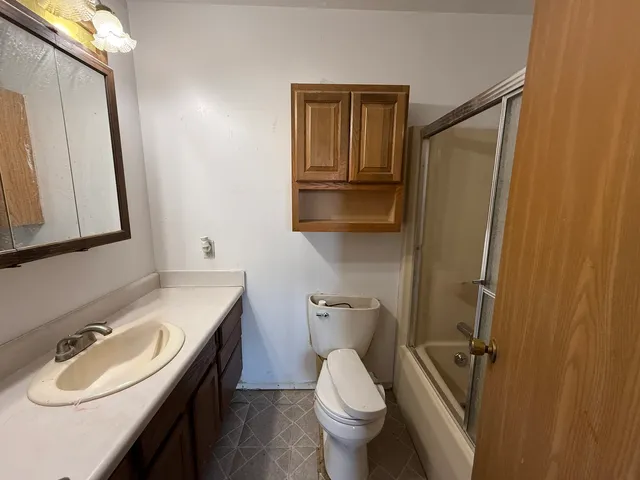 a bathroom with a sink a toilet and mirror