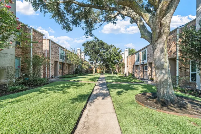 a pathway of a house with a yard