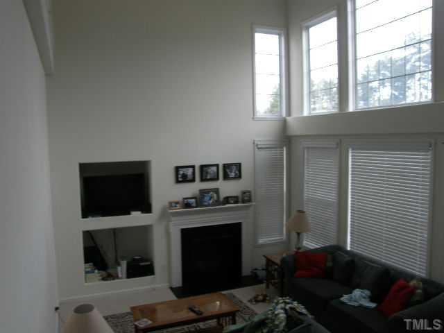 8 Drye Lane Durham, NC 27713 - Photo 2 of 9 a living room with furniture a flat screen tv and a fireplace