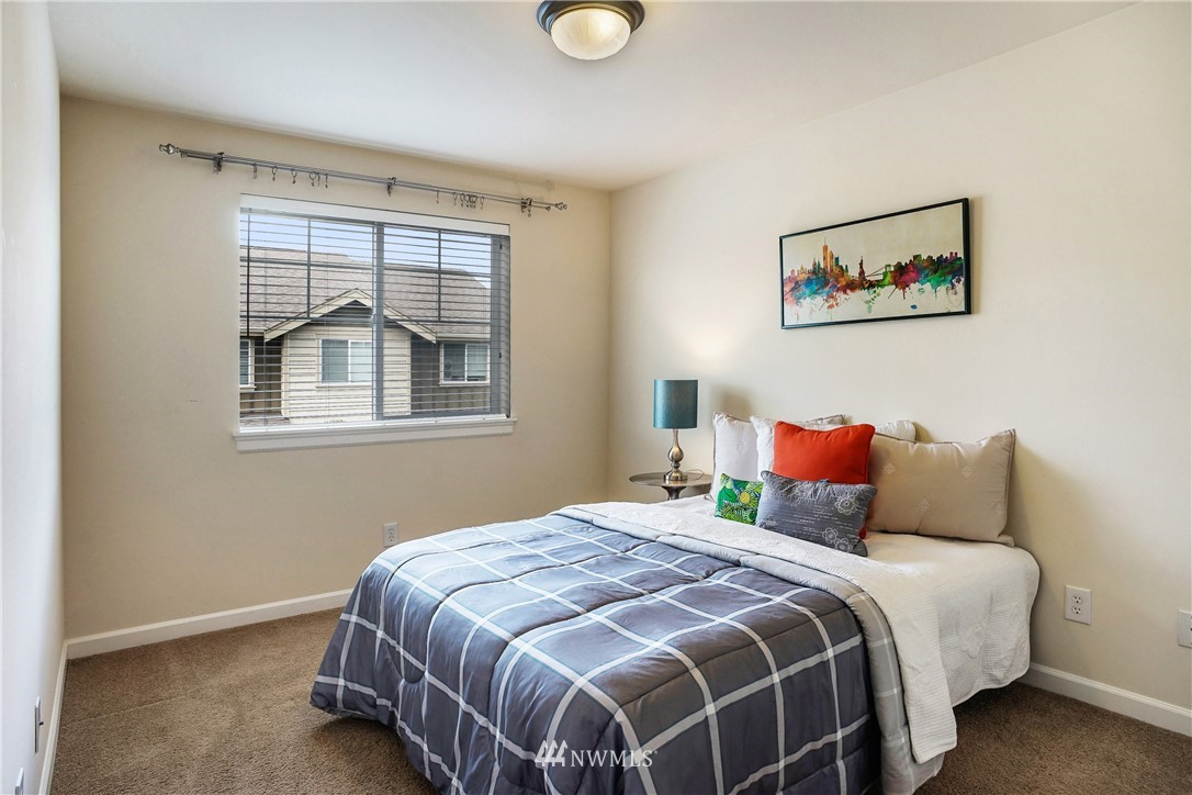 4651 Northeast 3rd Court, Unit A2 Renton, WA 98059 - Photo 22 of 24 a bedroom with a bed and a window