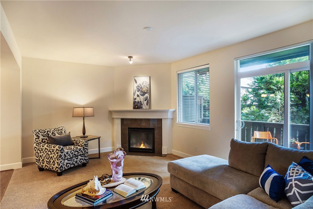 4651 Northeast 3rd Court, Unit A2 Renton, WA 98059 - Photo 8 of 24 a living room with furniture and a fireplace