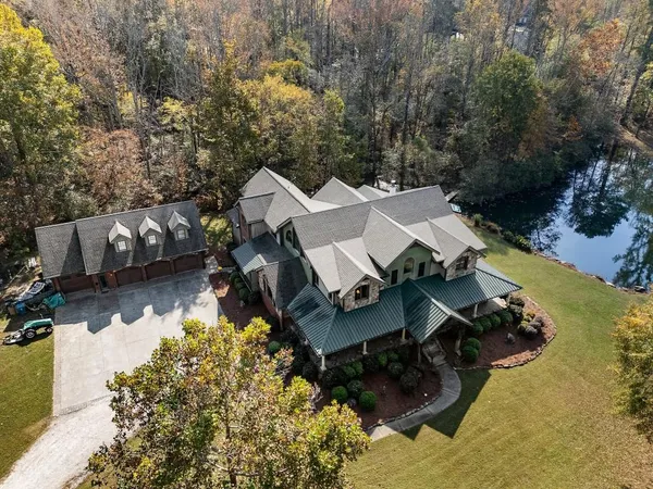 an aerial view of a house with a yard