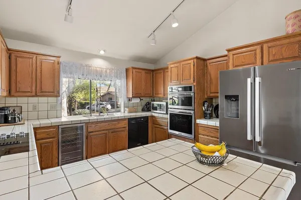 a kitchen with a sink stainless steel appliances and cabinets