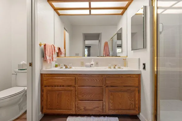 a bathroom with a double vanity sink and a mirror