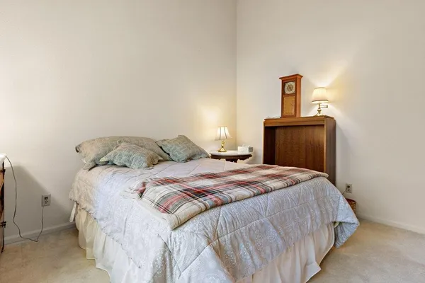 a bedroom with a bed and a mirror