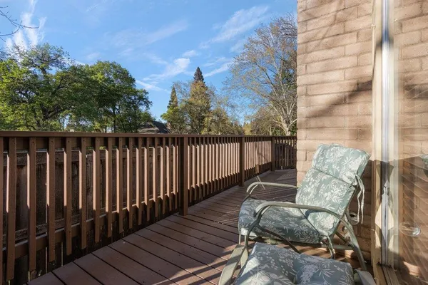 a view of wooden balcony with outdoor seating