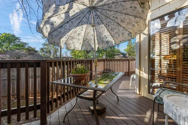 a view of a roof deck with furniture