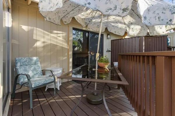 a view of balcony with wooden floor and outdoor seating