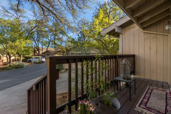 a view of balcony with wooden floor and outdoor seating