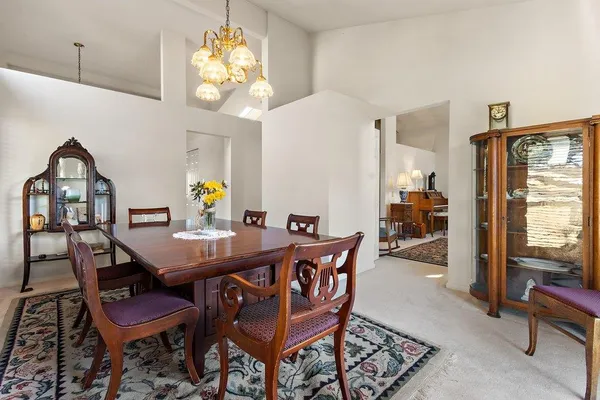 a view of a dining room with furniture and chandelier