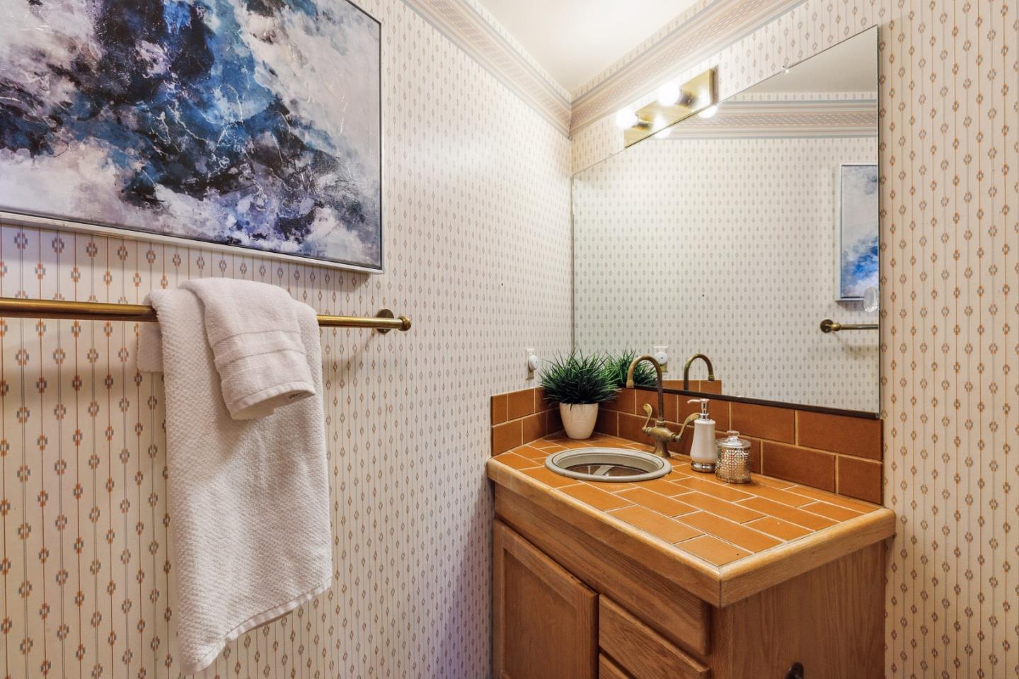22114 Miller Ridge Road Los Gatos, CA 95033 - Photo 49 of 100 a bathroom with a sink and a mirror
