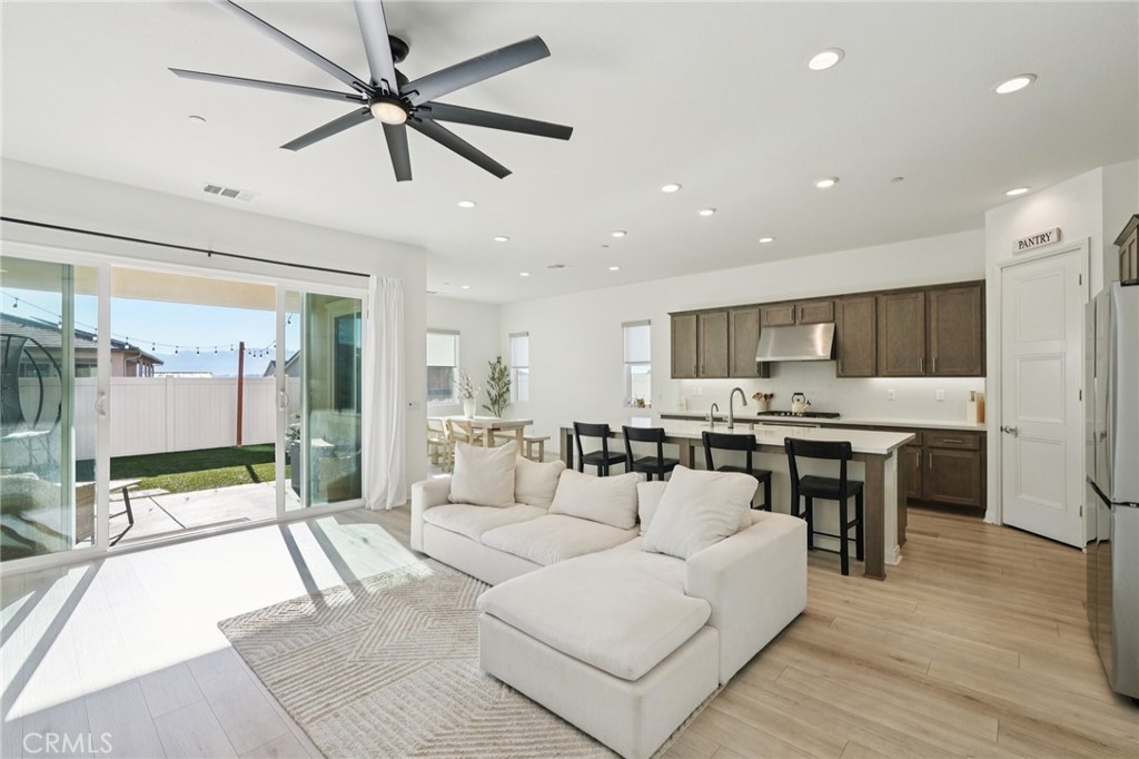 39481 Chamise Temecula, CA 92591 - Photo 4 of 34 a living room with stainless steel appliances kitchen island granite countertop furniture a rug kitchen view and a chandelier