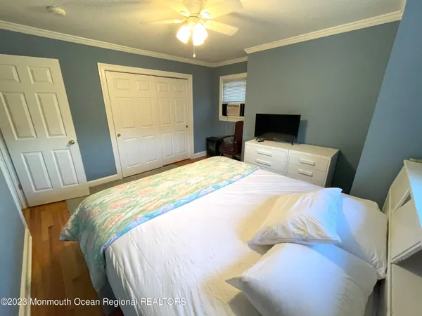 a bedroom with a bed and a mirror