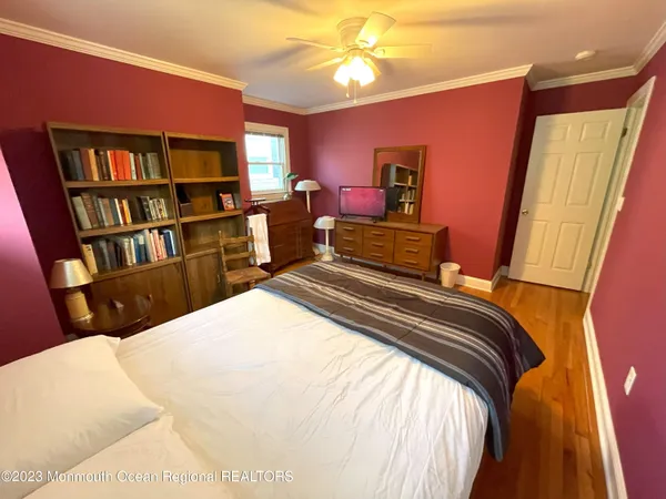 a bedroom with a bed and a book shelf
