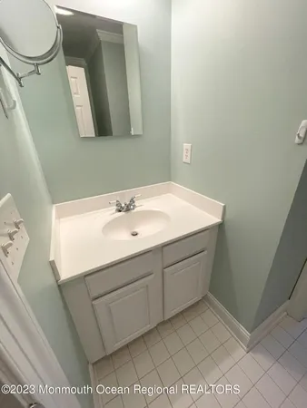 a bathroom with a sink toilet and mirror