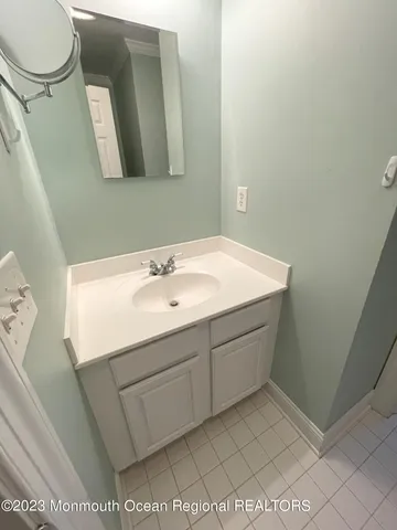 a bathroom with a sink toilet and mirror